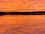 A view of the lake at sunset at GONE FISHING RV RESORT - thumbnail