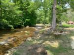 Rocking bench with creek view at Sugar Hollow RV Park and Campground - thumbnail