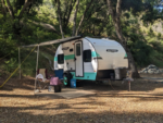 Trailer in a dirt site at Blue Lakes Village RV Park - thumbnail