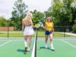 Two women playing pickle ball at OCEANS RV RESORT - thumbnail