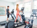 A woman and man in the exercise equipment at OCEANS RV RESORT - thumbnail