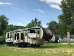 5th wheel in the grass at Pocono Point RV & Campground - thumbnail