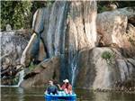 People on a boat near the waterfall - thumbnail