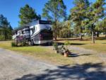 View of RV parked in a camp site at HITCHINPOST RV PARK AND CAMPGROUND - thumbnail