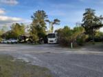 Gravel drive with view of several camp sites at HITCHINPOST RV PARK AND CAMPGROUND - thumbnail