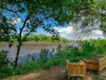 Seating area along the river at RIVERSHIRE RV RESORT & CAMPING - thumbnail