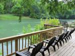 Chairs line the deck along the river at RIVERSHIRE RV RESORT & CAMPING - thumbnail