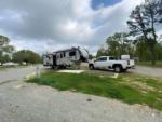Parked trailer next to pick up truck at The Farm RV Park - thumbnail