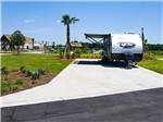 A travel trailer parked in a paved site at TROPIC HIDEAWAY RV RESORT - thumbnail