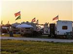 Parked RVs with flags flying high at WORLD WIDE TECHNOLOGY RECEWAY CAMPGROUND - thumbnail