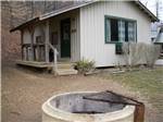 A rental cabin with a porch and fire pit - thumbnail