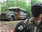 A man holding a paintball marker - thumbnail