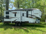 Camper surrounded by trees at Sterling Creek Campground - thumbnail