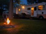 Large RV and fire pit at Rustic Oak RV Park - thumbnail