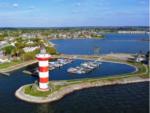 Aerial view of the marina and lighthouse at TWISTED PARROT LUXURY RV RESORT - thumbnail