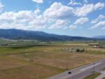 Aerial view of the grassy area and mountains at GRAND BUFFALO RV RESORT - thumbnail