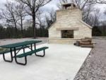 A large fireplace and picnic table at HOT ROD HILL RV PARK - thumbnail