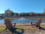 Two Adirondack chairs next to the lake at NEW CANEY RV PARK - thumbnail