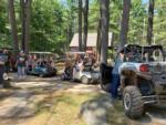 A group of campers in golf carts and ATVs at PEACEFUL PINES FAMILY CAMPGROUND - thumbnail