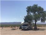 RV parked at a shaded site at Mountain Meadows RV Park - thumbnail