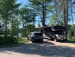 SUV and RV in gravel site at Wildwood Outdoor Adventures and Campground - thumbnail