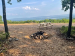 Fire pit and table at site at 100 Mile View Camping - thumbnail