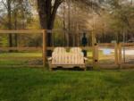 A wooden bench inside the pet area at DOGWOOD RV PARK - thumbnail