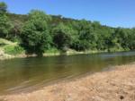 A view of the river with trees nearby at BRAZOS RIVER HIDEOUT - thumbnail