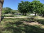 Picnic benches and fire pit at RV sites at BRAZOS RIVER HIDEOUT - thumbnail