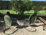 Green chairs around a fire pit at BRAZOS RIVER HIDEOUT - thumbnail