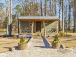 A front view of one of the rustic rental cabins at SANWAR RV PARK & RESORT - thumbnail