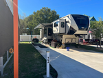A fifth wheel in a paved site at Aledo Acres RV Park - thumbnail