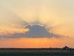 Sunburst behind a cloud at SILVER WIND RV PARK AND CABINS - thumbnail