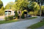 Large RV parked at a gravel site at Rocky Top Campground - thumbnail