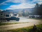 Parked trailer next to pickup truck at Rocky Top Campground - thumbnail