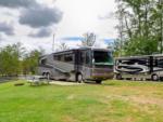 RVs by river and table at Paradise Ranch RV Resort - thumbnail