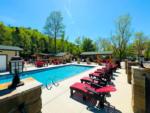 Swimming pool with lounge chairs at DUDLEY CREEK RV RESORT - thumbnail