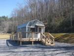 Small gray cabin at SWEETWATER SIGHTS RV PARK & CABIN RENTALS - thumbnail