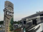 A motorhome parked next to the park sign at TIMBER RIDGE RV PARK - thumbnail