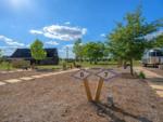 Airstream at site and a building in the distance at STARDUST AIRSTREAM RV RESORT AT CEDAR BREAK LODGING - thumbnail