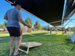 Family playing corn hole at STARDUST AIRSTREAM RV RESORT AT CEDAR BREAK LODGING - thumbnail