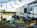 Family preparing a meal at a picnic at SANDUSKY RV RESORT - thumbnail