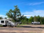 Parked trailers near open RV spaces at Wheelers RV Park - thumbnail