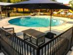 Outdoor pool with playground in the background at SILO CREEK RV RESORT - thumbnail