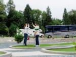 A couple high-fiving on the mini golf course at ANGEL OF THE WINDS CASINO RESORT - thumbnail