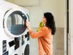 A woman doing laundry in the laundry facility at ANGEL OF THE WINDS CASINO RESORT - thumbnail