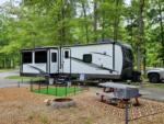 Trailer with picnic table and fire ring at MOUNTAIN TOP RV PARK - thumbnail