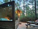 Cabin with picnic table in front at Tranquil Cabins - thumbnail
