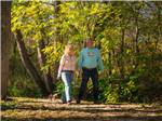 A couple walking on a wooded path - thumbnail