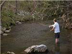 A person fly fishing in a river - thumbnail